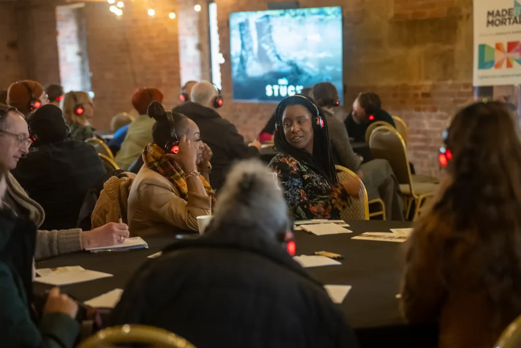 Group of women listening to audio story for a interactive workshop