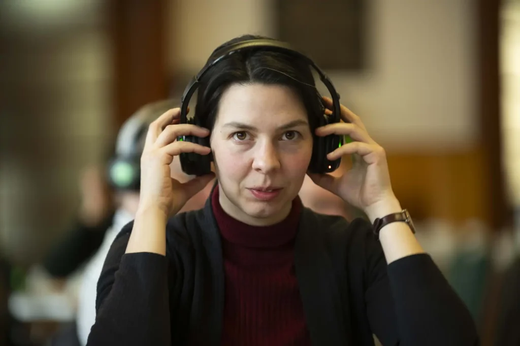 Women listening to audio stories of shared experience on headphones
