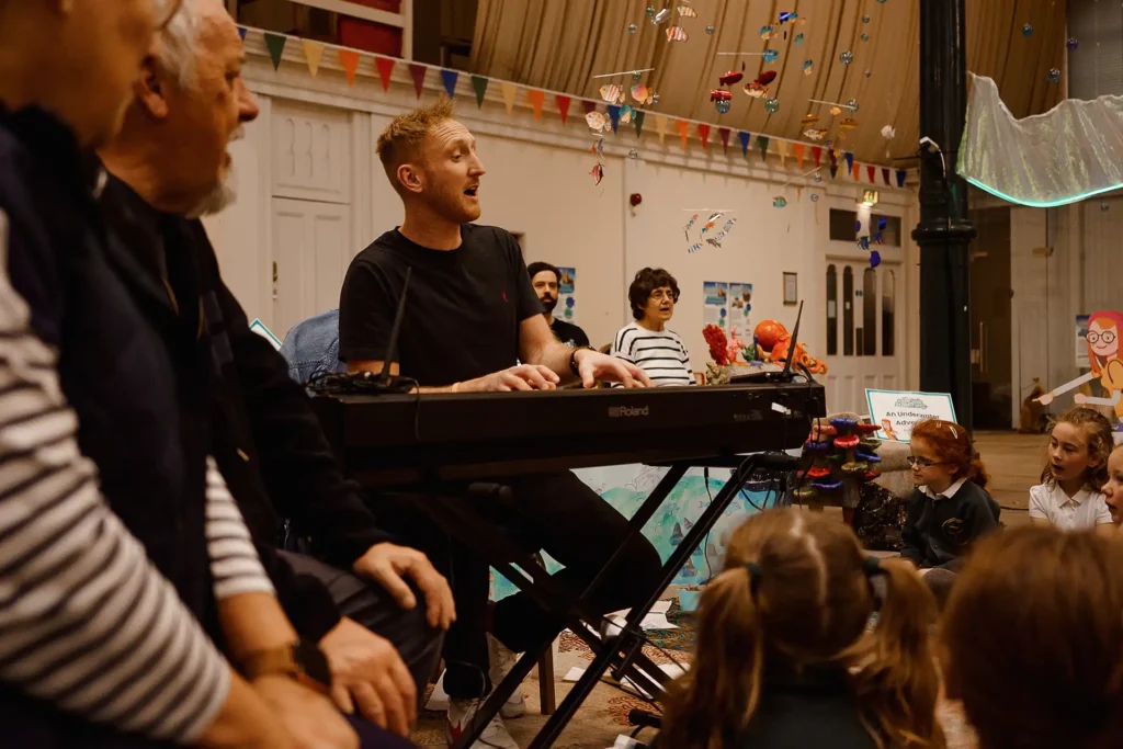 Made By Mortals Andy Smith performing with a group to produce Participatory Arts